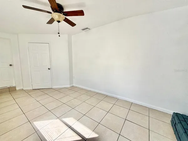 a view of an empty room and wooden floor