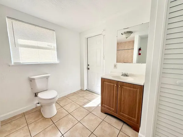 a bathroom with a sink a toilet and mirror
