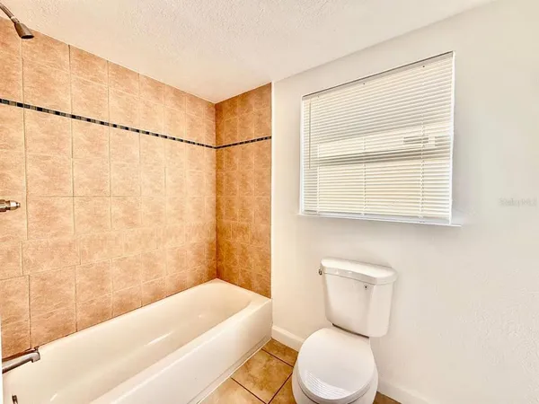 a bathroom with a toilet a sink and a bathtub