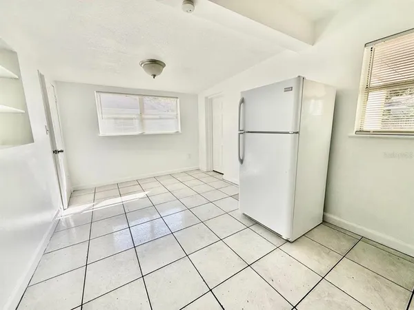 a view of a refrigerator in kitchen and entryway