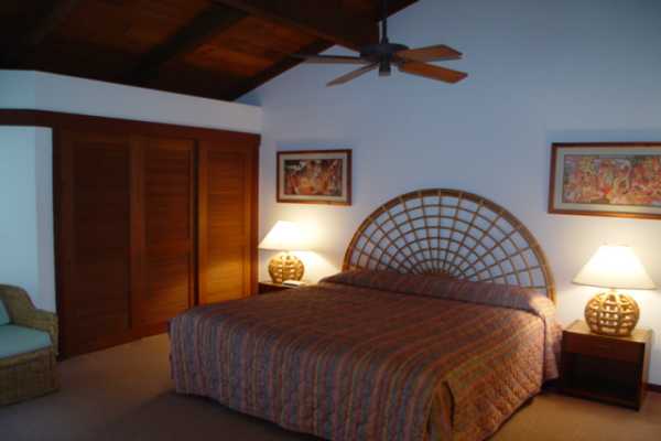 1870 Hoone Road, Unit 525 Koloa, HI 96756 - Photo 17 of 19 a bedroom with a bed and a lamp on the dresser