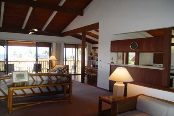1870 Hoone Road, Unit 525 Koloa, HI 96756 - Photo 5 of 19 a living room with furniture a lamp a rug and a large window