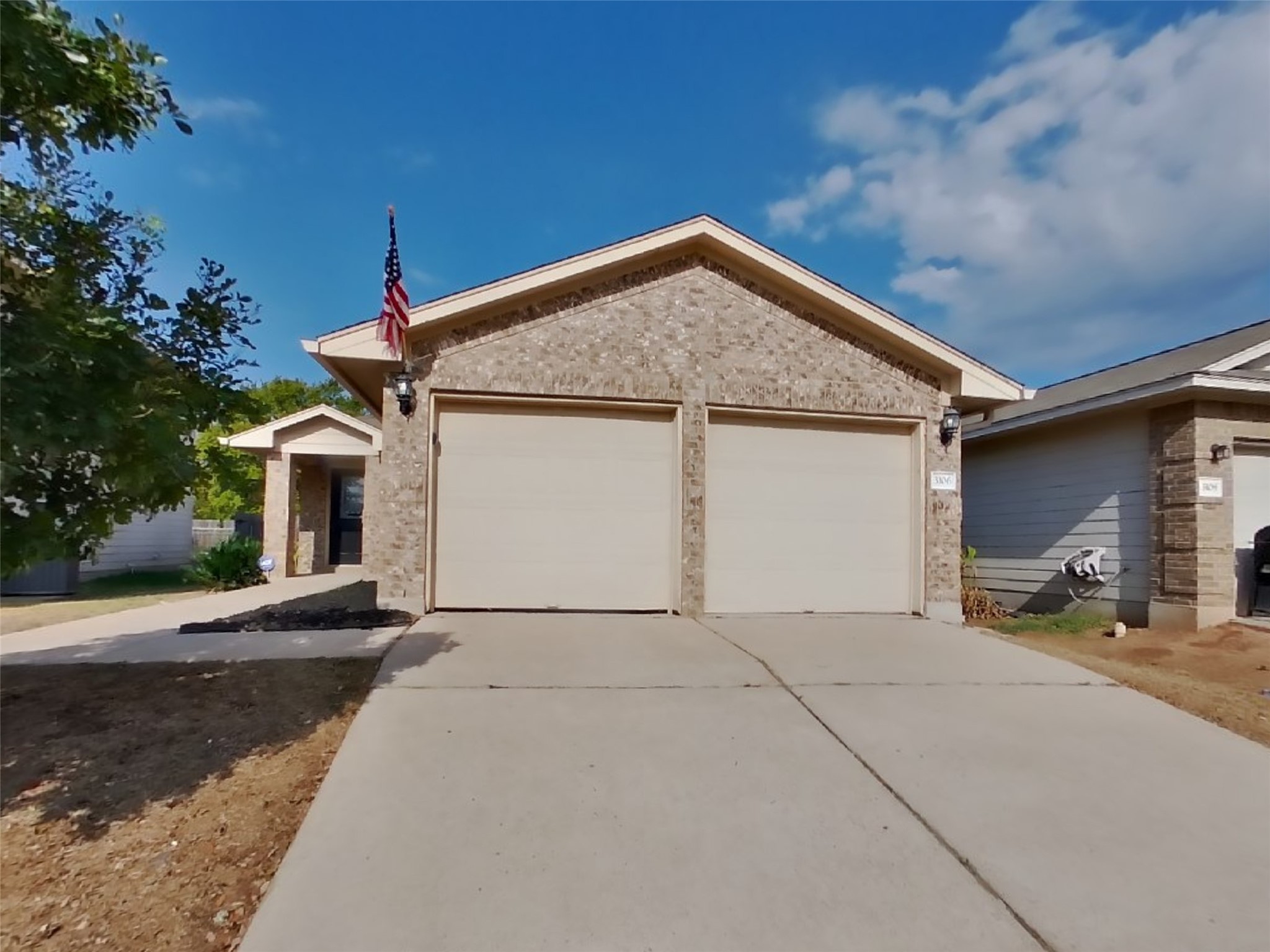 Ranch-style home with driveway, a garage, and brick siding