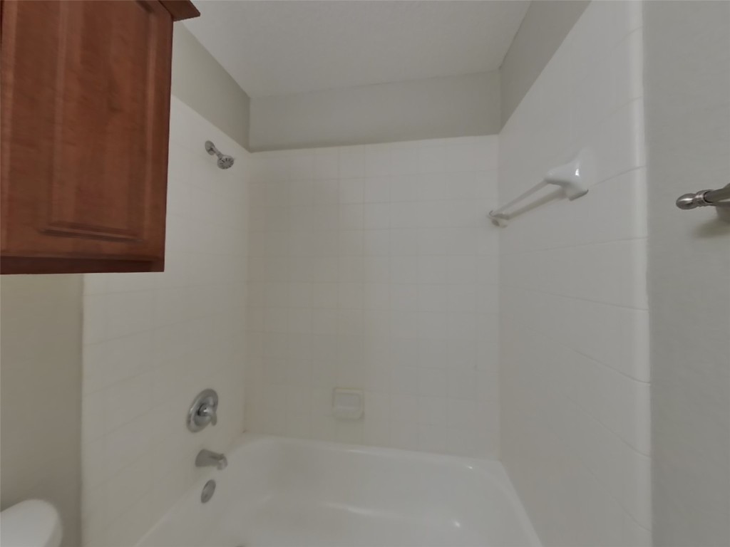 3106 Wickham Lane Austin, TX 78725 - Photo 14 of 16 a bathroom with a bathtub