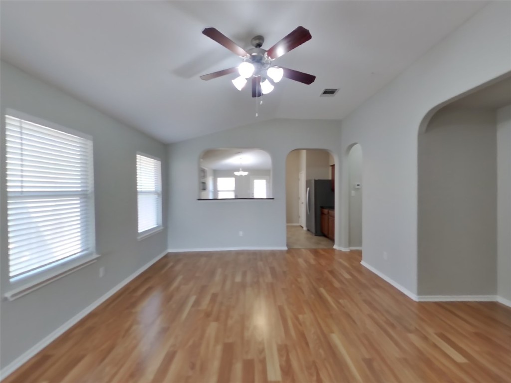 3106 Wickham Lane Austin, TX 78725 - Photo 3 of 16 a view of an empty room with window and wooden floor