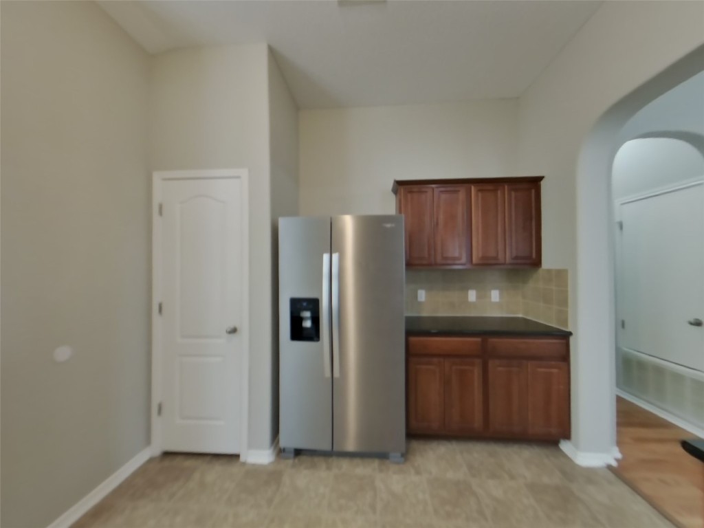 3106 Wickham Lane Austin, TX 78725 - Photo 6 of 16 a kitchen with a refrigerator and cabinets