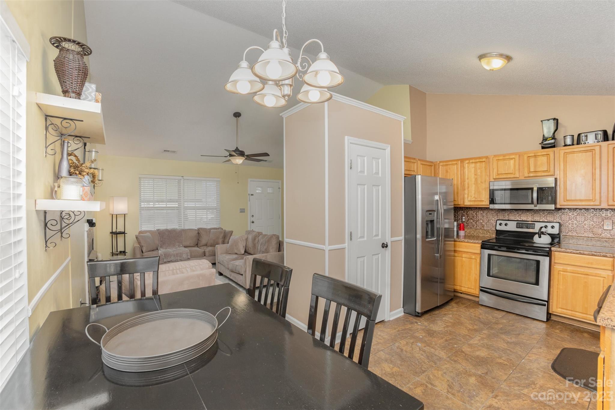 3144 Strong Gastonia, NC 28052 - Photo 15 of 26 a kitchen with a table chairs stove and refrigerator