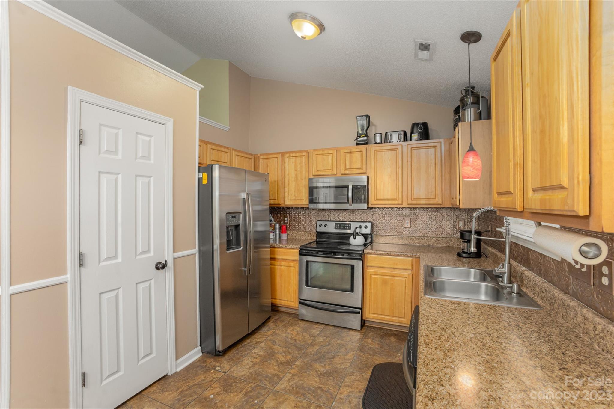 3144 Strong Gastonia, NC 28052 - Photo 16 of 26 a kitchen with stainless steel appliances granite countertop a refrigerator a stove and a sink with wooden floor