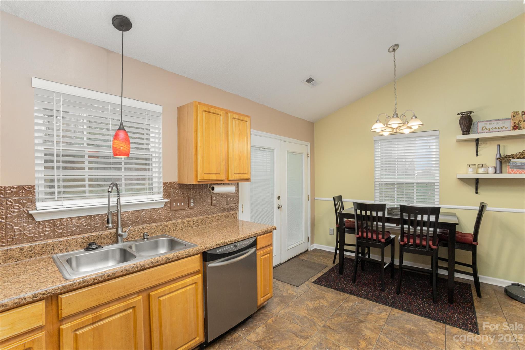 3144 Strong Gastonia, NC 28052 - Photo 18 of 26 a kitchen with a dining table chairs sink and cabinets