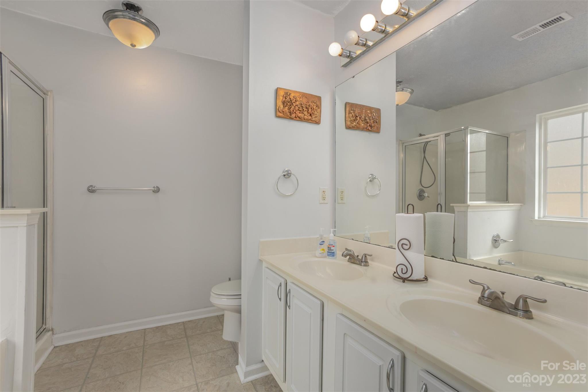 3144 Strong Gastonia, NC 28052 - Photo 21 of 26 a bathroom with a sink a toilet and shower