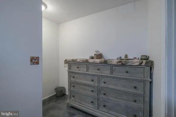 a bedroom with a bed and a book shelf