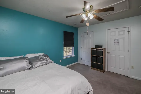 a bedroom with bed and window