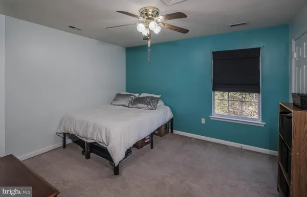 a view of backyard with wooden fence and trees