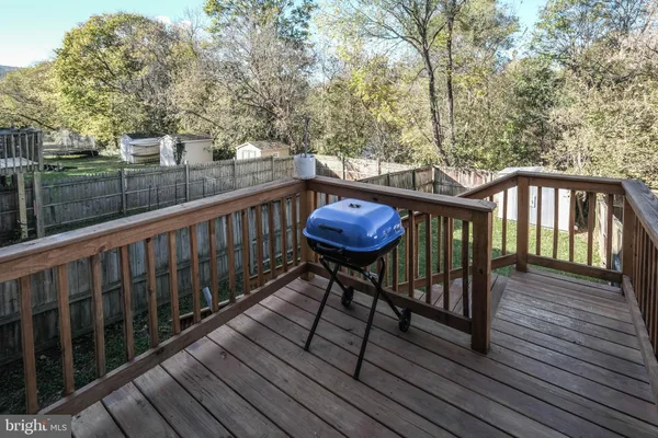 a view of balcony with wooden floor and outdoor seating