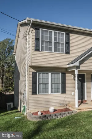a view of a building with sitting area and furniture