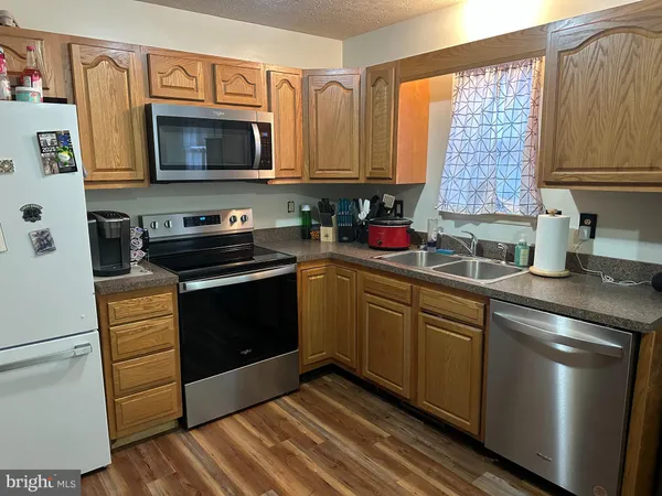 a kitchen with a sink stove and microwave