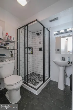 a bathroom with a sink toilet and shower