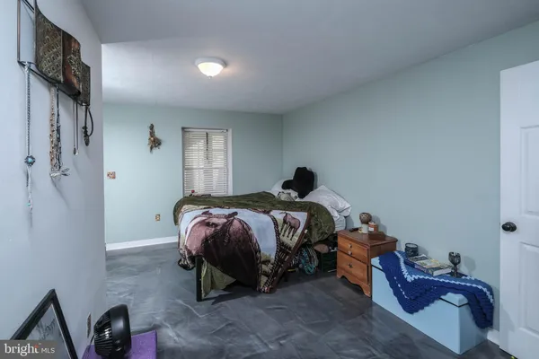 a bedroom with a bed and a mirror