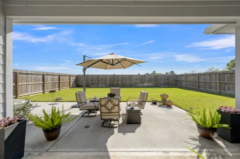 a view of a couches and dinning table and chairs in patio