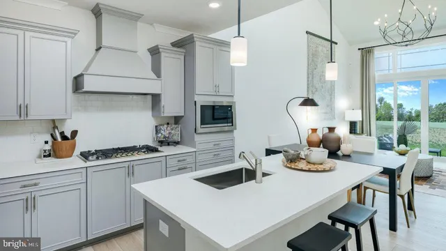 a kitchen with a stove a table and chairs in it