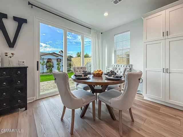 a front view of a house with a yard table and chairs