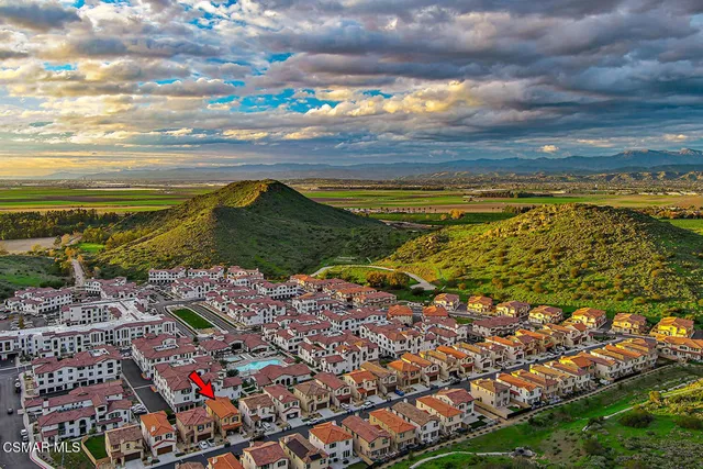an aerial view of a multi story building with yard