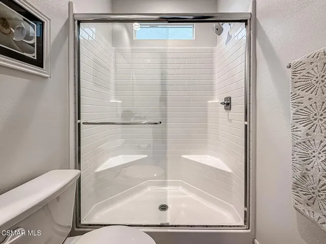 a view of a storage and utility room with washer and dryer