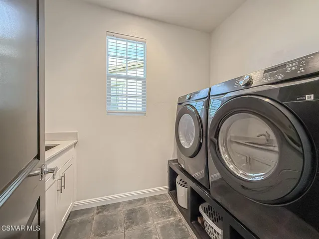 a living room with couches and a large window