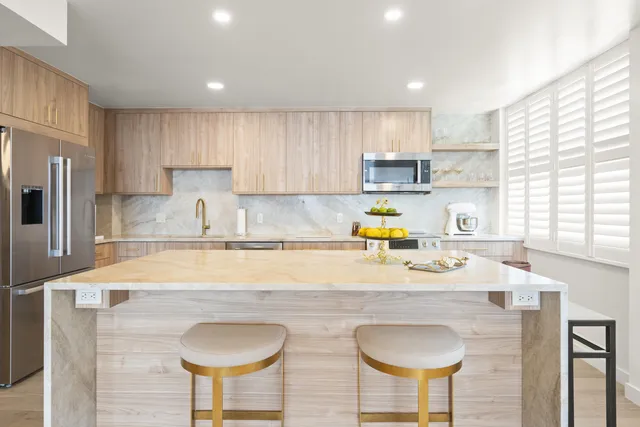 a kitchen with a sink a stove a counter space and cabinets