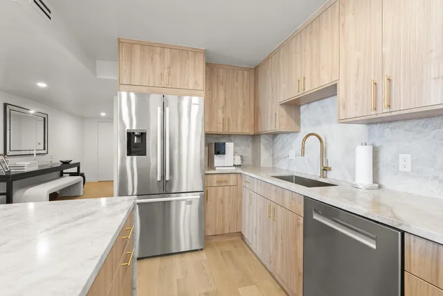 a kitchen with a sink appliances and cabinets