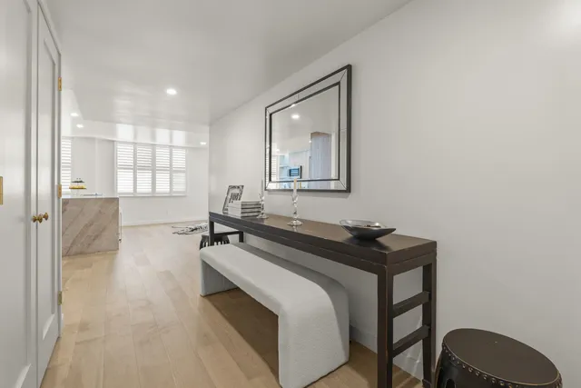 a dining room with table chairs and wooden floor