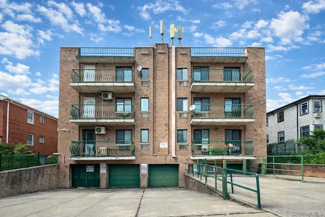 a view of a brick building with a bench in front of building
