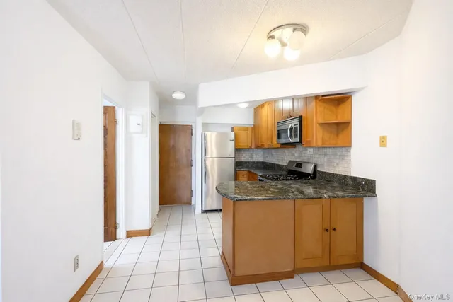 a bathroom with a granite countertop sink a mirror and a shower