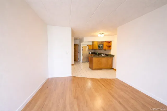 a room with a bed and wooden floor