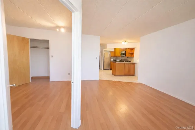 a view of a kitchen with a sink and a refrigerator