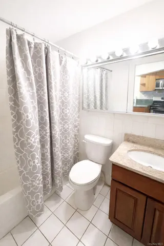 a bathroom with a sink toilet and window
