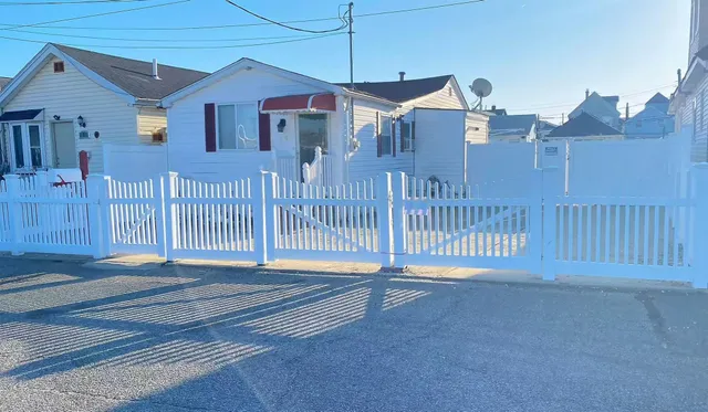 a front view of a house with a street