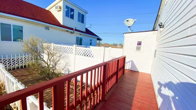 a view of a balcony with wooden floor
