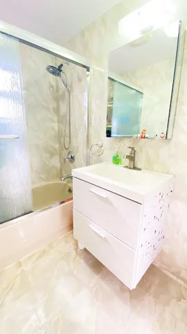 a bathroom with a sink a mirror and a bathtub