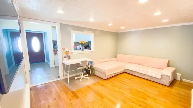 a spacious bedroom with a bed a couch and a potted plant