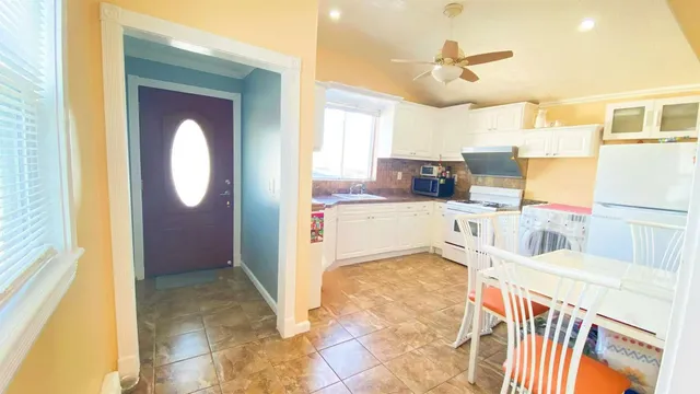 a kitchen with a sink appliances and cabinets