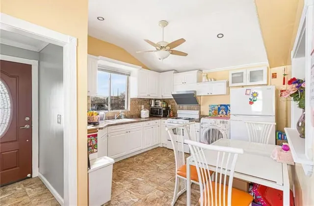 a kitchen with cabinets and window