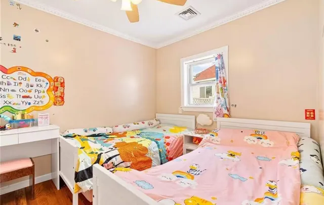 a bed sitting in a bedroom next to a window