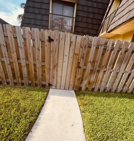 a view of a backyard with wooden fence