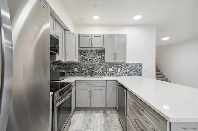 a kitchen with a sink stove and cabinets