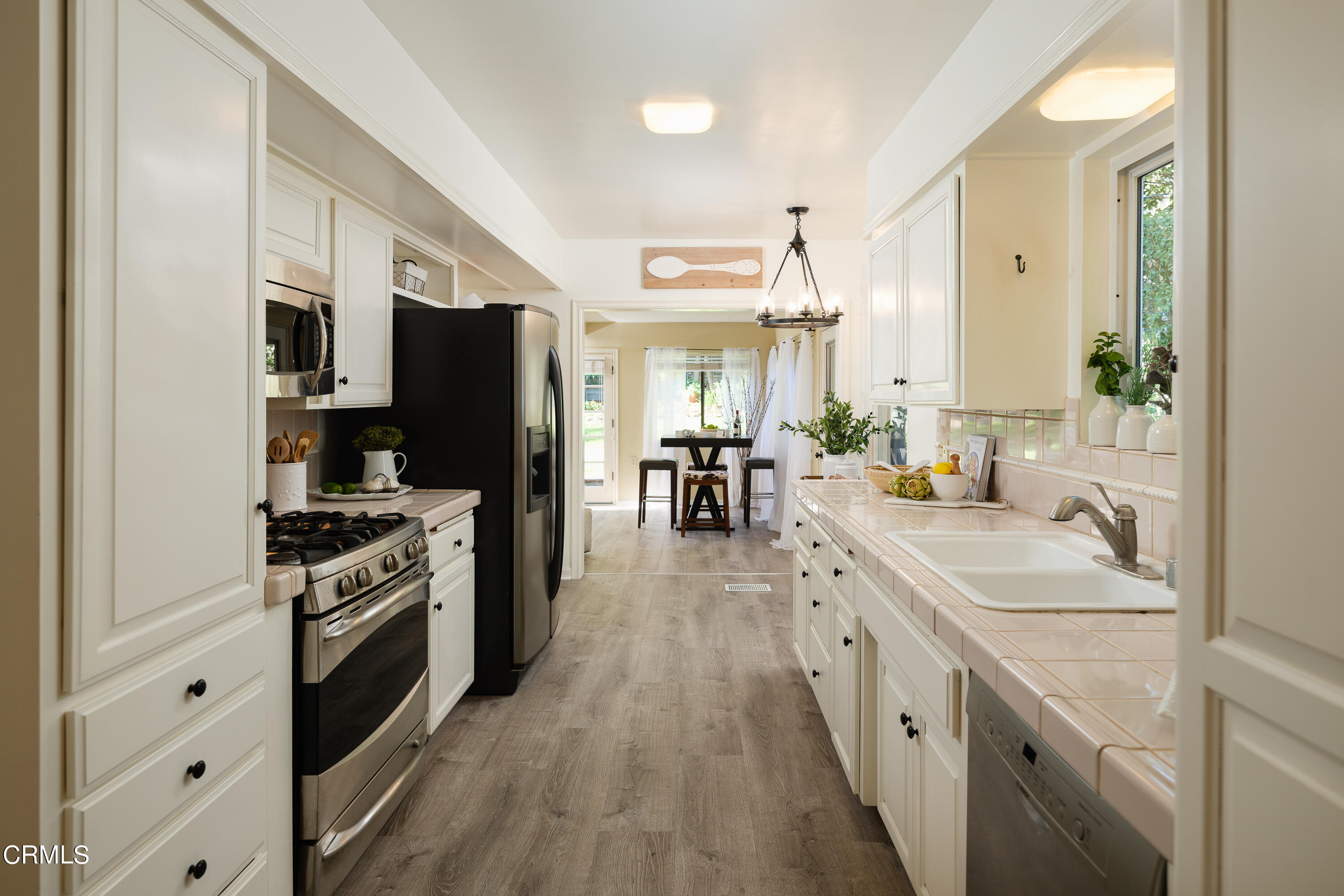 981 Parkman Street Altadena, CA 91001 - Photo 22 of 75 a large kitchen with stainless steel appliances granite countertop a lot of counter space and wooden floor