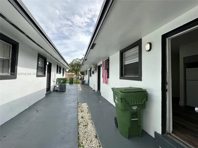 a view of a house with backyard porch and sitting area