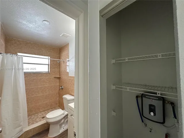 a bathroom with a toilet and a shower