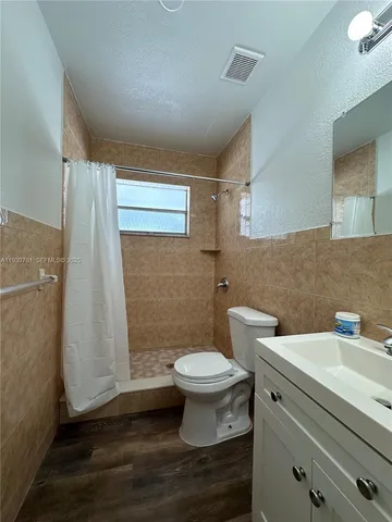 a bathroom with a sink a toilet and a shower