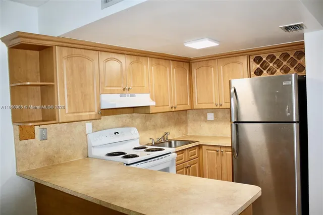 a kitchen with a refrigerator a stove and a refrigerator